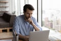 Pensive young Caucasian male employee work on computer Royalty Free Stock Photo