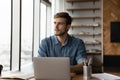 Pensive Caucasian man work on laptop thinking Royalty Free Stock Photo