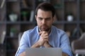 Pensive man work on laptop thinking of problem Royalty Free Stock Photo