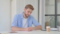 Pensive Young Man Writing on Paper, Thinking Royalty Free Stock Photo