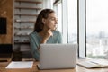 Pensive female employee work on laptop thinking Royalty Free Stock Photo