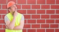 Pensive young man builder with hard hat Royalty Free Stock Photo