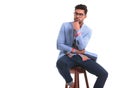 Pensive young man sitting on a chair. Royalty Free Stock Photo