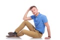 Pensive young man sitting on the floor Royalty Free Stock Photo