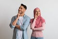 Pensive young muslim couple thinking about something and looking away Royalty Free Stock Photo