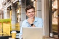 Pensive young stylish man in shirt working on laptop Royalty Free Stock Photo