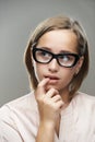 Pensive young woman in glasses