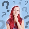 Pensive young woman with interrogation marks Royalty Free Stock Photo