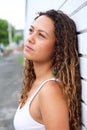 Pensive young woman leaning against a wall Royalty Free Stock Photo