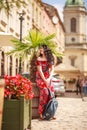 Pensive Woman In Long Colorful Dress On Street Of Tourist Old European City