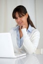 Pensive young woman reading on laptop screen Royalty Free Stock Photo