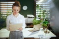 pensive young woman real estate agent in modern green office Royalty Free Stock Photo