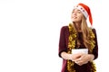 Pensive young woman in a Santa Claus hat, received a long-awaited Christmas gift on a white background. Royalty Free Stock Photo