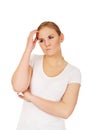 Pensive young woman scratching her head Royalty Free Stock Photo