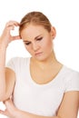 Pensive young woman scratching her head Royalty Free Stock Photo