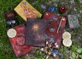 Pentagram, magic book of spells, pentagram and witch objects on the grass