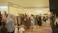 peolple wallking around and buying hijab and watching at event hijab trend expo 2021