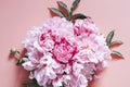 Peonies bouquet flowers in full bloom vibrant pink color isolated on pale pink background. flat lay, top view, space for text. ban Royalty Free Stock Photo