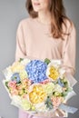 Peonies and hydrangea. Beautiful bouquet of mixed flowers in woman hand. Floral shop concept . Handsome fresh bouquet