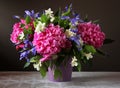 Peonies, irises and Jasmine in a bouquet. Garden flowers in a va
