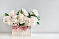 Peonies in a rustic basket, front view