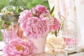 Peony bunch in vase on the table in the garden with color effect