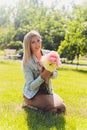 Peony flower. Cute woman smelling pink flower. Beautiful girl with flower. Romantic girl hold peony flower in park Royalty Free Stock Photo