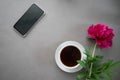 Peony on a gray background cup of coffee phone planning