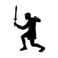 Silhouette of a male fighter with battle armor and sword weapon. Royalty Free Stock Photo