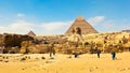 People admire the greatness of the stone Sphinx, pyramids and ancient architecture of Giza Plateau in Egypt Royalty Free Stock Photo