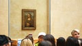 People admiring famous iconic Monna lisa Painting of Leonardo in Louvre Museum