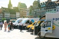 People admiring the fleet of electrical vehicles of postal opera