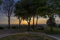 People admiring the sunset from a panoramic terrace in the medieval village of Castagneto Carducci, Tuscany, Italy