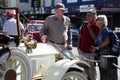 People admiring a vintage car at a vintage car show in Motueka High Street in front of the museum