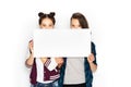 Happy teenage girls holding blank white board Royalty Free Stock Photo