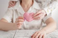 People, age, family, love and health care concept - close up of senior woman and young woman hands holding red heart Royalty Free Stock Photo
