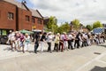 People of all ages line dancing in the street.