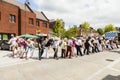 People of all ages line dancing in the street.