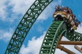 People amazing terrific Cheetah Hunt rollercoaster on lightblue cloudy sky background 77