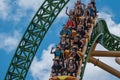 People amazing terrific Cheetah Hunt rollercoaster on lightblue cloudy sky background 80