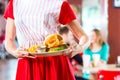 People in American diner or restaurant eating fast food Royalty Free Stock Photo