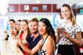 People in American diner or restaurant with milk shakes Royalty Free Stock Photo