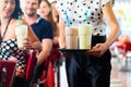 People in American diner or restaurant with milk shakes Royalty Free Stock Photo