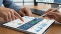People analyzing financial data charts and graphs on a tablet and computer screen business Royalty Free Stock Photo