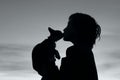 People, animals, pets, childhood concept. Silhouette of an owner and pet. Silhouette of young girl holding a cat, cropped shot. Royalty Free Stock Photo