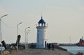 People approaching the old lighthouse on the seafront of the Mangalia city in Romania Royalty Free Stock Photo