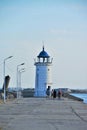 People approaching the old lighthouse on the seafront of the Mangalia city in Romania