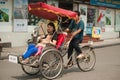 People in the area taking a cyclo ride in Hanoi,Vietnam.