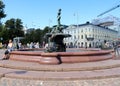 Crowded day at the Havis Amanda statue in Helsinki, Finland