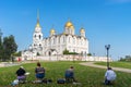 People artist paints a picture a holy Assumption Cathedral Orthodox church outdoors in the autumn sunny day in the park